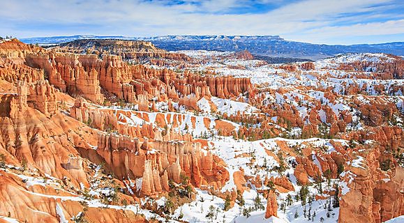 Snow-covered ground and hoodoo rock in Bryce Canyon National Park, Utah.