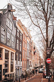 Canal houses lining a waterway in Amsterdam.