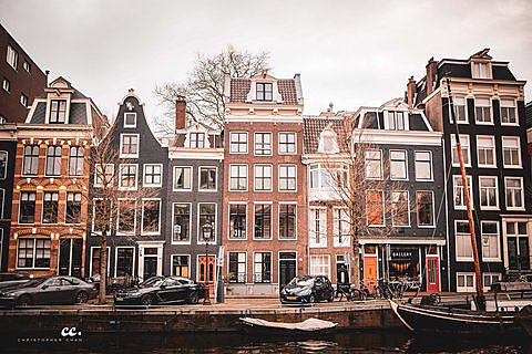 Canal houses lining a waterway in Amsterdam.